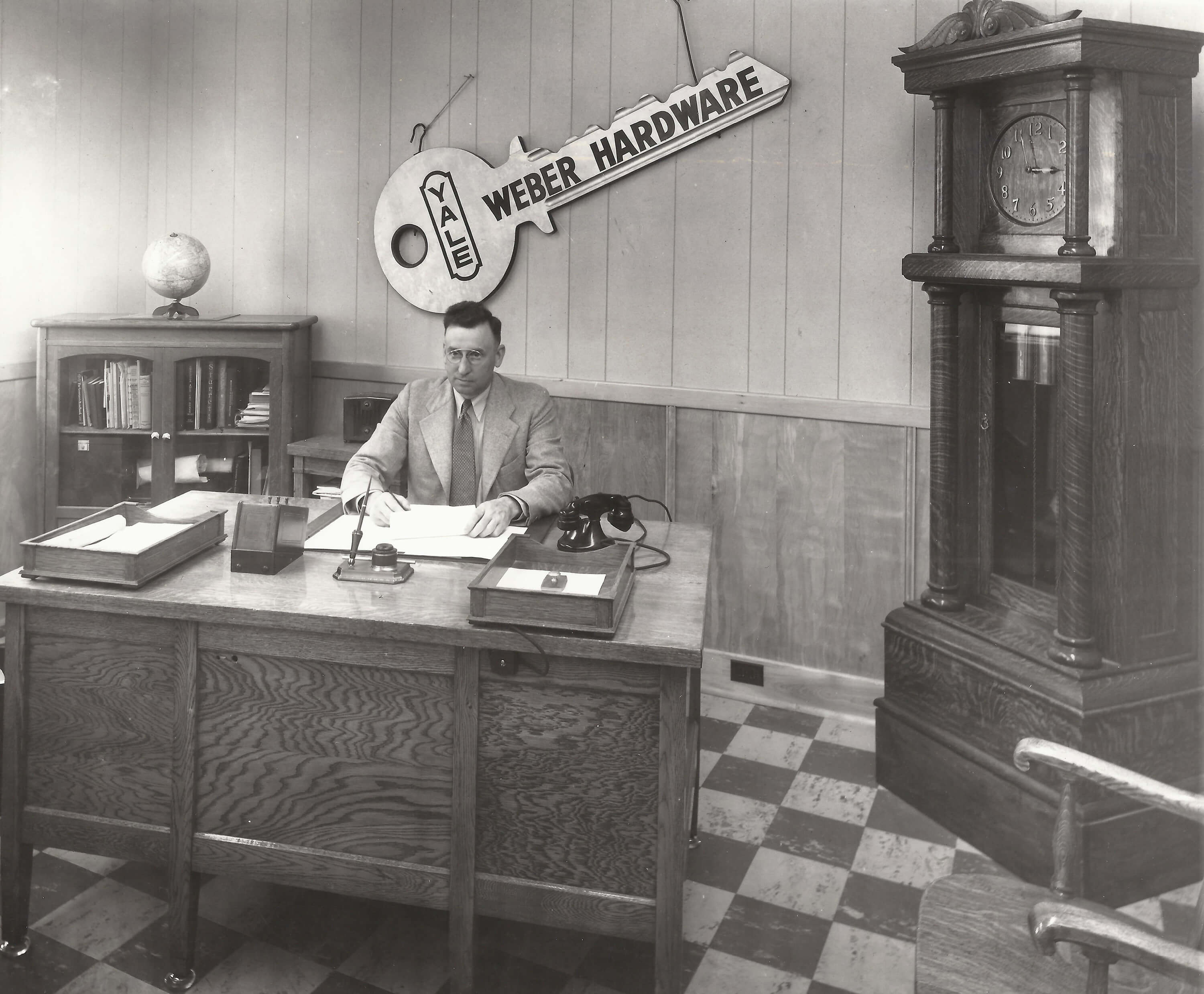 Carl Weber sitting at his desk in 1923